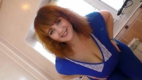 A red-haired BBW milf danced a striptease for a neighbor who was watching her through the window